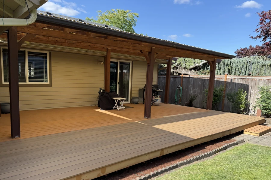 Covered composite deck and cedar pergola outdoor living space built by Tekton Construction in Oregon